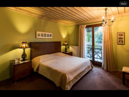 a bedroom with a large bed and a window at Boutique Hotel Skamnos Arachova in Arachova