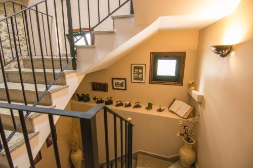 a staircase with a stair case with vases at Casa Puertas in Oia