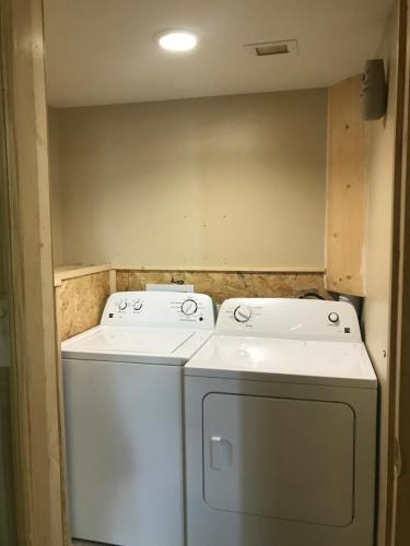 a laundry room with a washer and dryer at Dexter Inn in Dexter