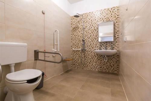 a bathroom with a toilet and a sink at Apartments Hana in Pula