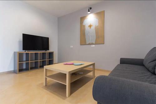 a living room with a couch and a coffee table at Apartments Hana in Pula