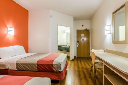 a hotel room with two beds and a bathroom at Motel 6-Kearney, NE in Kearney