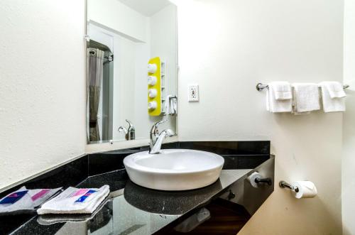 a bathroom with a sink and a mirror at Motel 6-Kearney, NE in Kearney