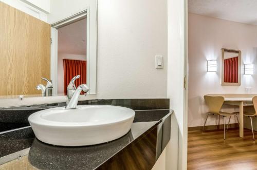 a bathroom with a white sink on a counter at Motel 6-Kearney, NE in Kearney