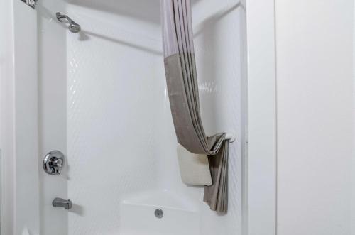 a shower door with a towel hanging from it at Motel 6-Kearney, NE in Kearney
