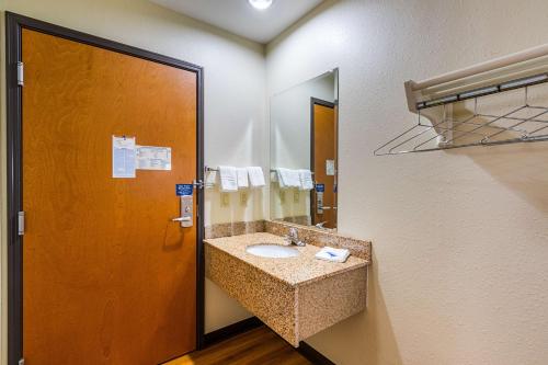 a bathroom with a sink and a mirror at Motel 6-Urbana, IL in Champaign