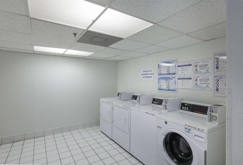 a laundry room with a washer and dryer at Motel 6-Bedford, TX - Fort Worth in Bedford
