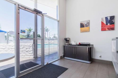 a room with a sliding glass door with a view of a pool at Motel 6 Bakersfield in Bakersfield