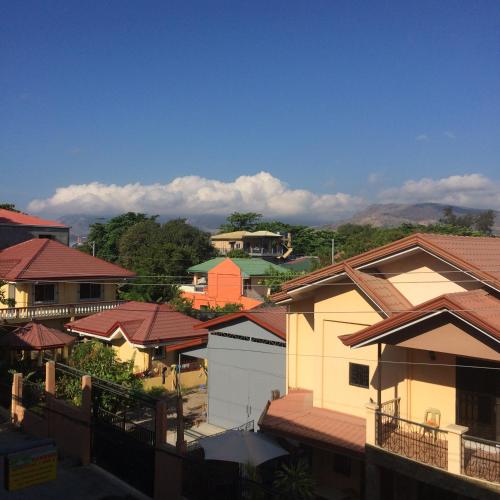 a group of houses with mountains in the background at Sunrise Apartelle in Olongapo