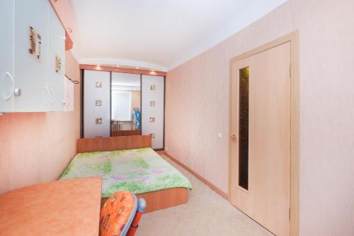 ノヴォシビルスクにあるNSK-Kvartirka, Apartment Vatutina, 23の小さなベッドルーム(ベッド1台、テーブル付)
