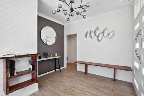 a hallway with a bench and a mirror at Thunderbird Motel Yass in Yass