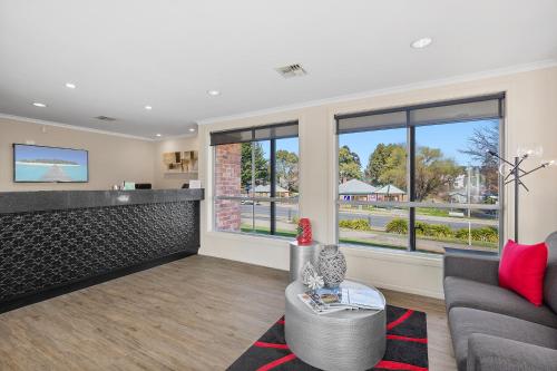 a living room with a couch and a table at Thunderbird Motel Yass in Yass