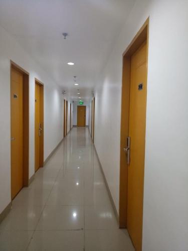 a hallway of a building with wooden doors and a hallwayngth at Meaco Royal Hotel - Batangas City in Batangas City