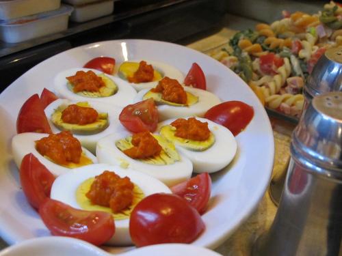 a plate of deviled eggs and tomatoes on a table at Arbia Dorka Heritage Palace in Varaždin