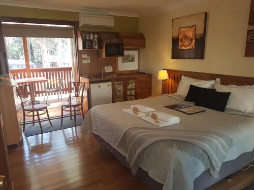a bedroom with a bed with two towels on it at Adamsons Riverside Accommodation in Margaret River Town