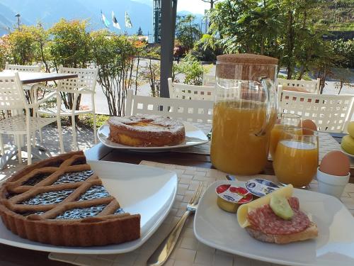 a table topped with plates of food and drinks at Garden View in Anfo