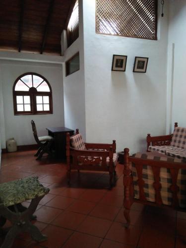a living room with two chairs and a window at Beatrice House Galle Fort - Homestay in Galle