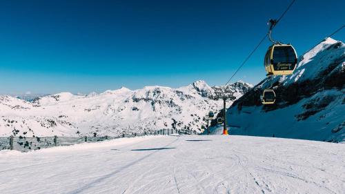 a ski lift going up a snow covered mountain at Luxury Apartment in Ramingstein