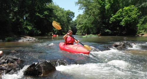 a woman is in a kayak in a river at Luxury Apartment in Ramingstein