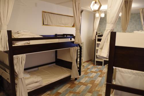 Postel nebo postele na pokoji v ubytování Cinnamon Guesthouse Dogo