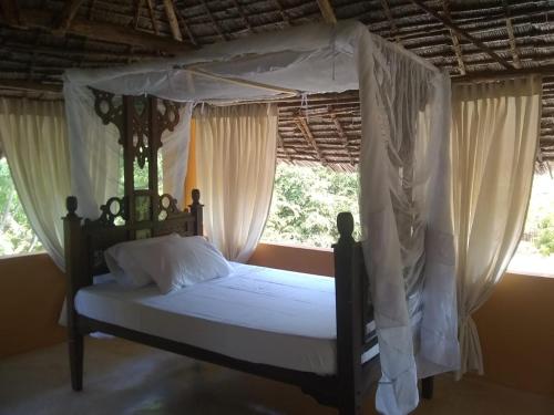 A bed or beds in a room at Mangrove House