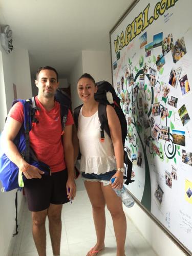 a man and a woman standing in front of a wall at Vagibi Hotel in Dong Hoi