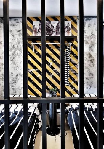 a view of a wine cellar through a black fence at Escapade Prison Suites Petaling Jaya in Petaling Jaya