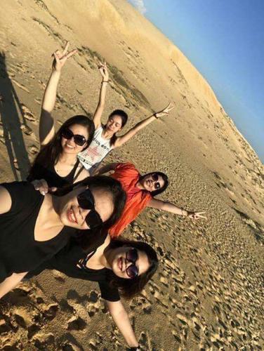 a group of women standing on the beach at Vagibi Hotel in Dong Hoi