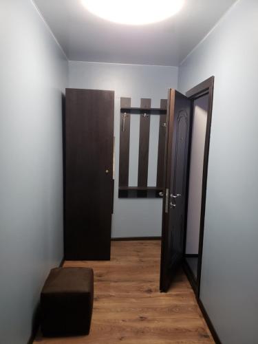 an empty room with two doors and a stool at Rhombus Hotel in Luts'k