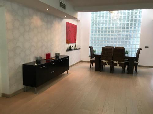 a dining room with a table and chairs in a room at Villa with Heated Pool and Jacuzzi close to Puerto Banus and Beach in Estepona