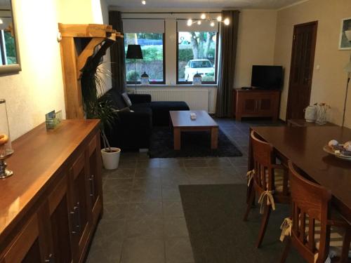 a living room with a couch and a table at Vakantiewoning Kleijnen in Noorbeek