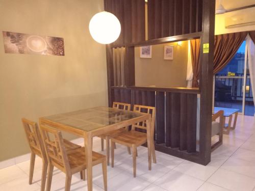 a dining room with a table and chairs at ZamLan Gold Coast Morib Intl Resort - 3 Rooms Apartment in Banting