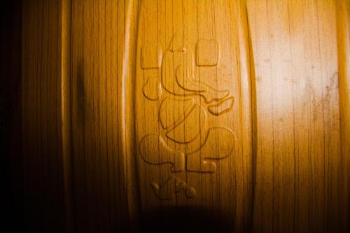 a wooden door with graffiti on the side of it at Riva homestay family room in Darjeeling