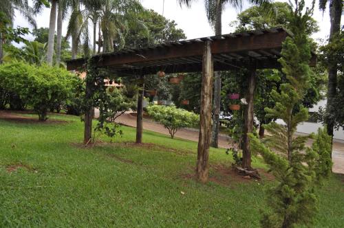 a pergola with potted plants on it in a park at Hotel Recreio São Jorge in Jaboticabal