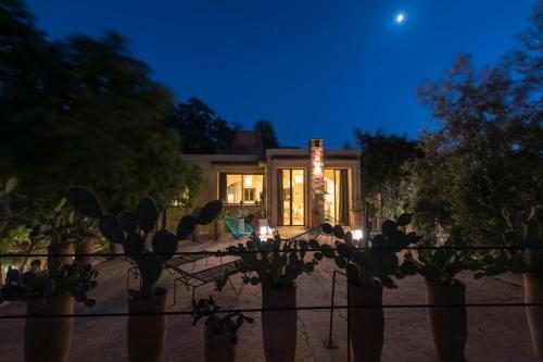 a house with a fence and plants in front of it at Dar al Hossoun in Taroudant