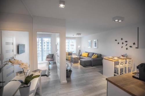 a living room with a couch and a table at Apartament Sedina E306 Park Polanki in Kołobrzeg