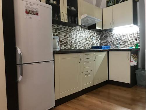 a kitchen with white cabinets and a refrigerator at Alžbetina 15 - DREAM apartmán in Košice