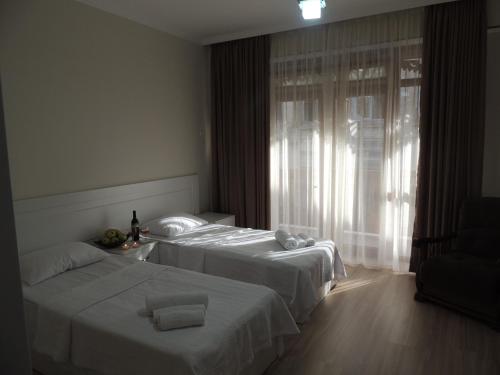 a hotel room with two beds and a window at Old Town in Gori