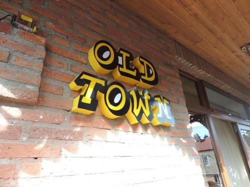 a sign that says old town on the side of a brick building at Old Town in Gori