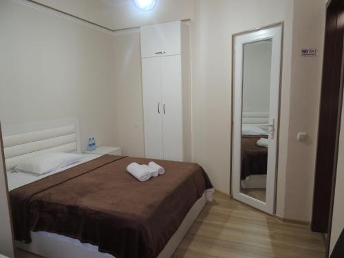 a bedroom with a bed with two towels on it at Old Town in Gori
