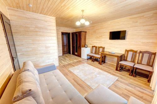 a living room with a couch and a table at Continental SPA Resort in Bukovel
