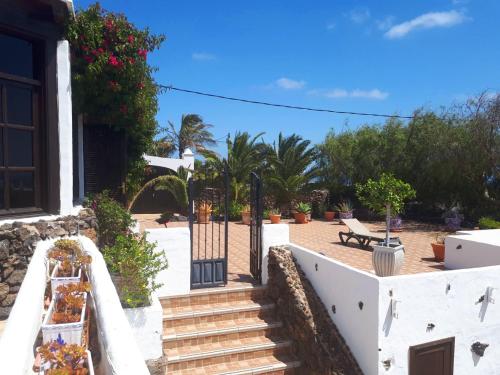 a stairway leading up to a house with a gate at Casa Tara - 5 bedroom, 4 bathroom villa with private pool in Mácher