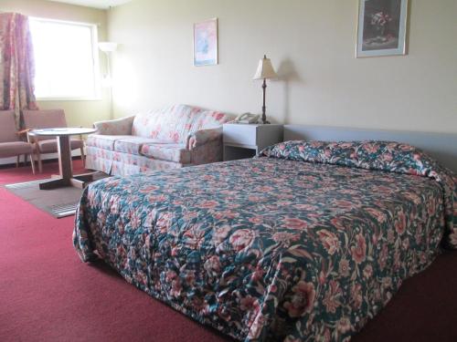una habitación de hotel con una cama y un sofá en Newburg Inn Motel, en New Hamburg