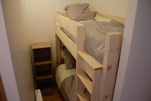 ein Etagenbett aus Holz in einem kleinen Zimmer in der Unterkunft 63 Route du Rochas in Vaujany