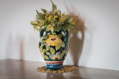 a vase with flowers in it sitting on a table at Lou Mas Dou Juge in Saintes-Maries-de-la-Mer