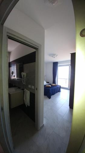 a view of a room with a bed and a mirror at B&B Aquila Reale in Portopalo