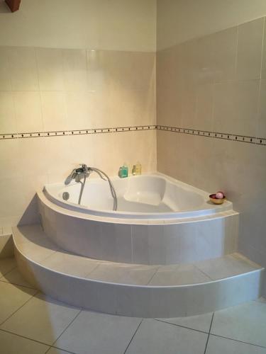 een bad met een kraan in de badkamer bij Appartement indépendant chez l'habitant in Bezons