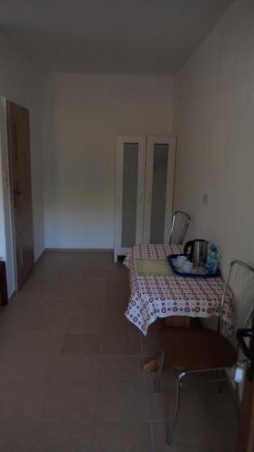 a room with a table and chairs with a table at Bacówka Noclegi in Sierpnica