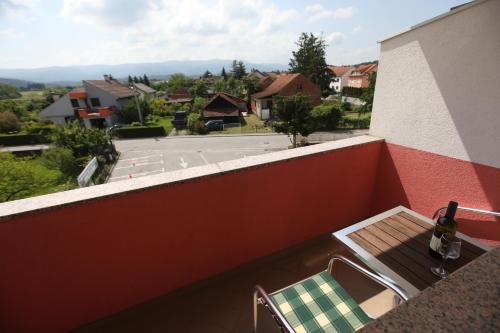 a bottle of wine sitting on the ledge of a balcony at Hotel Zagi in Oroslavje