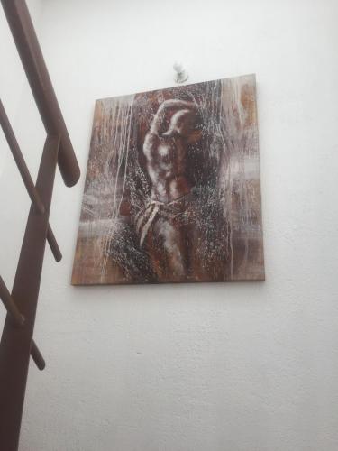 a painting of a man hanging on a wall at Residence Las Trojes Cdmx in Mexico City